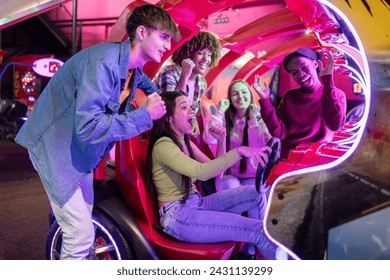 group of multiracial friends having fun playing video arcade and dancing in a night room with neon lights - Powered by Shutterstock