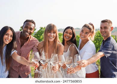 Group of multiracial friends having fun during wine tasting with vineyard in background - People and party concept - Powered by Shutterstock