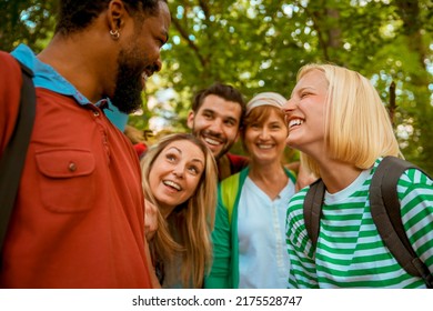 Group Of Multiracial Friends On Hiking In Green Forest Trail. Happy Smiling Young Diverse People In Woods