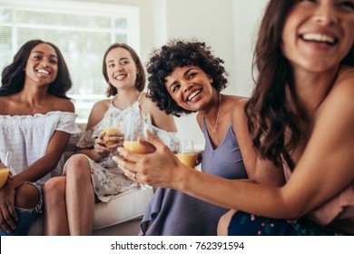 Group Of Multiracial Friends At A Party And Smiling. Women Friends Having A Party At Home And Looking Away.