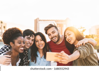 Group Multiracial Friends Taking Selfie With Mobile Smartphone Outdoor - Happy Mixed Race People Having Fun Outdoor - Youth Millennial Generation And Multiethnic Teenagers Lifestyle Concept 