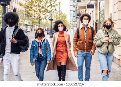 Group Of Multiracial Friends Walking On City Street With Protective Face Mask. Pandemic Time. Young People Lifestyle Concept. 