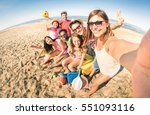 Group of multiracial happy friends taking selfie and having fun with beach sport games - Summer joy concept and multi ethnic friendship - Sunny afternoon color tones with focus on girl holding camera