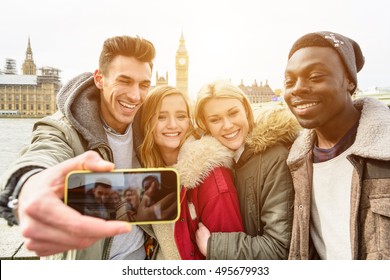 Group Of Multiracial Happy Friends Taking A Selfie With Westminster Palace At The Background With Big Ben Tower In London. Traveling Concept Of Happiness And Multi Ethnic People.