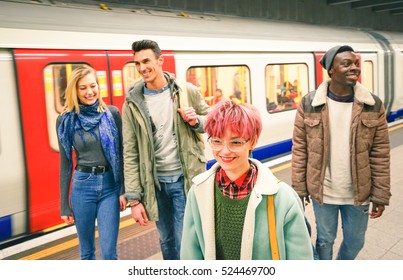 Group Of Multiracial Hipster Friends Having Fun In Tube Subway Station - Urban Friendship Concept With Young People Walking Together In City Underground Area - Vivid Color With Focus On Pink Hair Girl