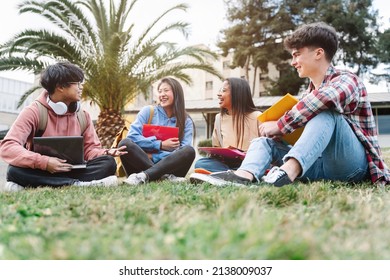Group of multiracial international exchange university student friends sitting on the grass in the college campus