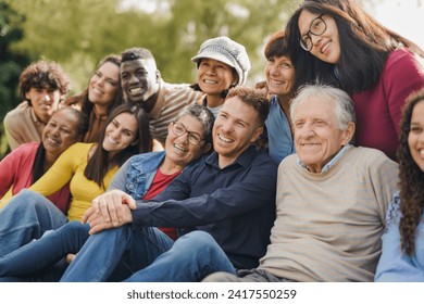 Group of multiracial people with different ages having fun together at city park - Community and social gathering concept - Powered by Shutterstock