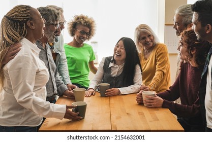 Group of multiracial people drinking coffee together indoor - Concept of multi generational friendship - Powered by Shutterstock