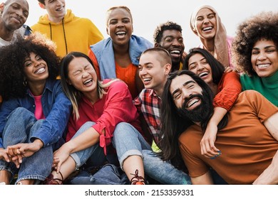 Group of multiracial people enjoy day at city park - Diverse young friedns having fun outdoor - Shutterstock ID 2153359331