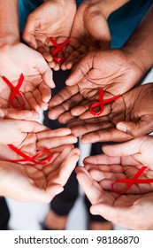 Group Of Multiracial People Holding Red Ribbon For AIDS HIV Awareness