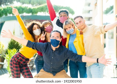 Group Of Multiracial People Wearing Protective Face Masks Smiling At Camera - New Normal Friendship Concept With Multicultural Friends Having Fun Outdoor - Focus On Asian Guy