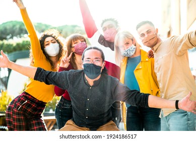 Group Of Multiracial People Wearing Protective Face Masks Smiling At Camera - New Normal Friendship Concept With Multicultural Friends Having Fun Outdoor - Focus On Asian Guy