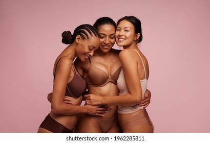 Group Of Multiracial Women In Underwear Hugging Each Other. Happy Woman Of All Ages.