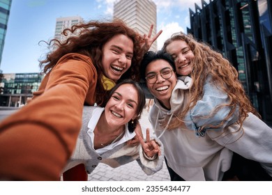 Group of multiracial young people having fun taking a selfie in the city with a smartphone. Happy friends hugging and looking at the camera. On vacation from University. - Powered by Shutterstock