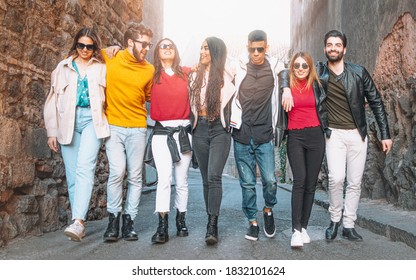 group of multi-racial young people hugging and walking together in the streets of the old town - Shutterstock ID 1832101624