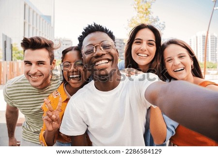 Group of multiracial young student people smiling and taking a selfie together. Close up portrait of happy african american teenager laughing with his cheerful friends. Classmates on friendly meeting