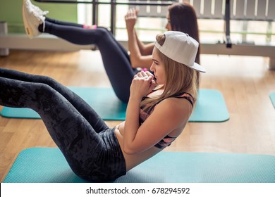 Group Of Muscular Womans Exercising Doing Sit Up Exercise