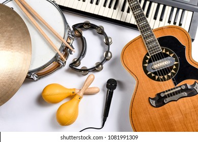 a group of musical instruments including a guitar, drum, keyboard, tambourine. - Shutterstock ID 1081991309