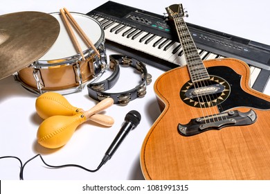 a group of musical instruments including a guitar, drum, keyboard, tambourine. - Shutterstock ID 1081991315