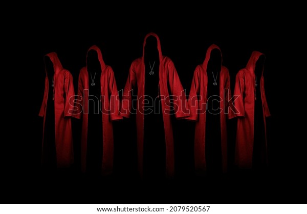 Group of mystery\
people in a red hooded cloaks.  Unrecognizable person. Hiding face\
in shadow. Ghostly figure. Satanic sect member. Conspiracy concept.\
Isolated on black.