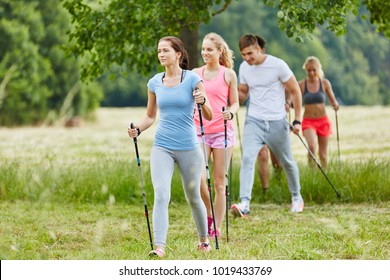 Group In The Nature Nordic Walking In Their Leisure Time