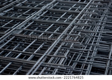 Group of new deformed bar or reinforced concrete construction steel net piles on outdoor ground. Selective focus and blurred for copy space.