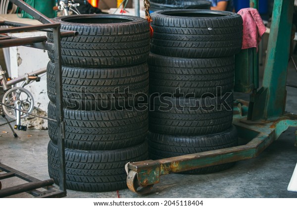 Group of new tires for race car.\
New tires for sale at a tire store. Car tires in the\
warehouse.