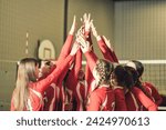 A group of nice teen sport in gymnase play volleyball