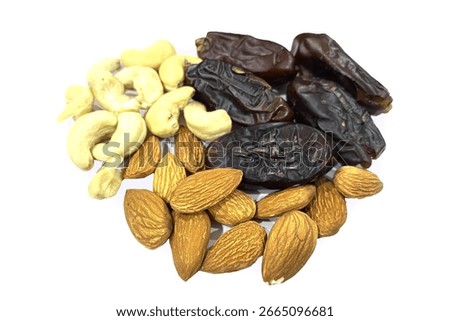 Group of Nuts Dry Dates,Cheshew Nuts and Almonds on the white Background