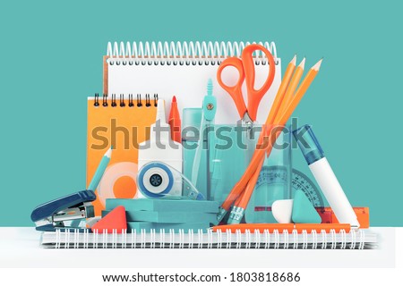 Group of office and school yellow orange and teal stationery on desk. Close up. Various supplies for back to school or education and craft concept. Selective focus. Copy space