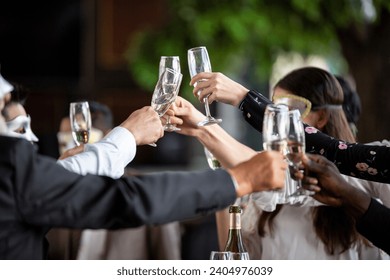 Group of office worker in fancy mask having celebration party. people cheers toasting wine glasses and talking together. business corporate company meeting in New Year party concept - Powered by Shutterstock