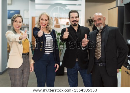 Group of office workers doing ok symbol at camera in clcihe image