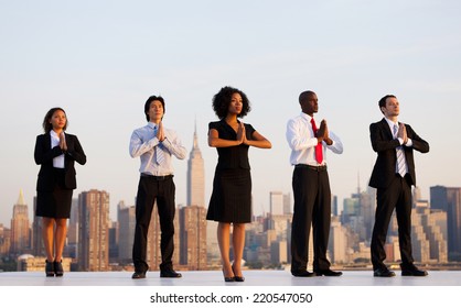 A group of office workers doing outdoor yoga. - Powered by Shutterstock
