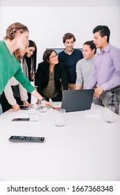 Group Of Office Workers At A Meeting Around The Boss