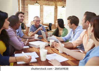 Group Of Office Workers Meeting To Discuss Ideas - Shutterstock ID 284569838
