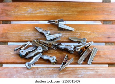 The Group Of The Old Aluminium Clothespin With Rust Stain On The Wooden Reclining Chair, Selective Focus Of The Object.