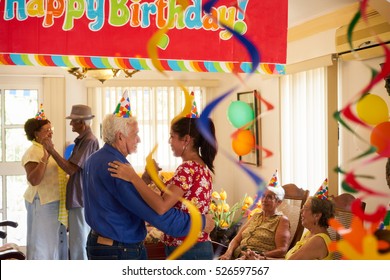 Group of old friends and family celebrating senior man birthday in retirement home. Happy elderly people having fun during party in hospice. - Powered by Shutterstock