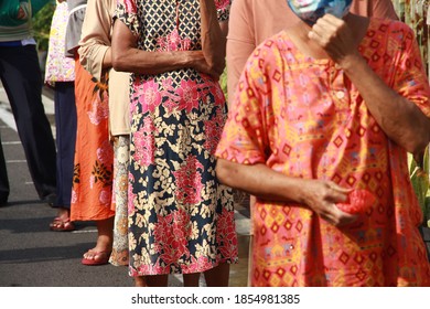 A Group Of Old People Sunbathing In The Morning Wearing Masks. The Concept Of A Healthy Lifestyle During The Corona Virus Outbreak.