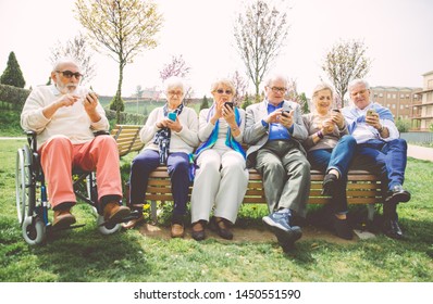 Group Of Old People Texting On The Smart Phones