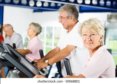 Group Of Older Mature People Exercising In The Gym