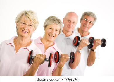 Group Of Older Mature People Lifting Weights In The Gym