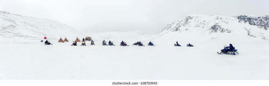 A Group On A Winter Snowmobile