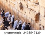 Group of orthodox Jews praying at Western Wall in Old City of Jerusalem, Israel