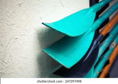 Group of paddles mounted on gray rural wall - Powered by Shutterstock