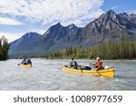 Group paddling down the whitewater of the Nahanni River in the Northwest Territories.