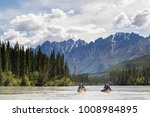 Group paddling down the whitewater of the Nahanni River in the Northwest Territories.