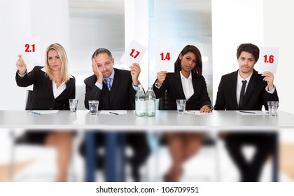 Group Of Panel Judges Holding Bad Score Signs