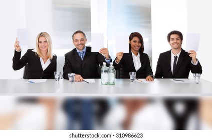 Group Of Panel Judges Holding Empty Score Signs