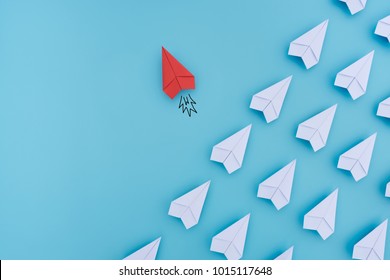 Group of paper planes in one direction and with one individual pointing in the different way. Business concept for innovative solution.