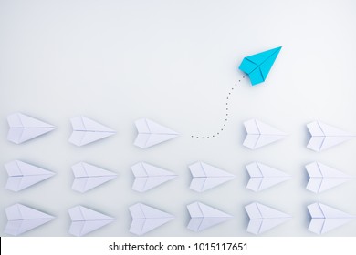 Group Of Paper Planes In One Direction And With One Individual Pointing In The Different Way. Business Concept For Innovative Solution.